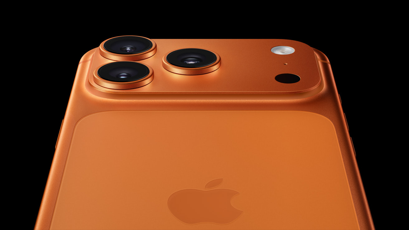 close-up of the iPhone 17 Pro triple-camera system on an orange
